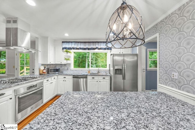 111 Bonwood Ave, Simpsonville, SC 29681 - kitchen with stainless steel appliances, island exhaust hood, white cabinets, light stone countertops, and crown molding