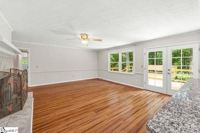 111 Bonwood Ave, Simpsonville, SC 29681 - unfurnished living room with wood finished floors, plenty of natural light, a ceiling fan, ornamental molding, and a textured ceiling