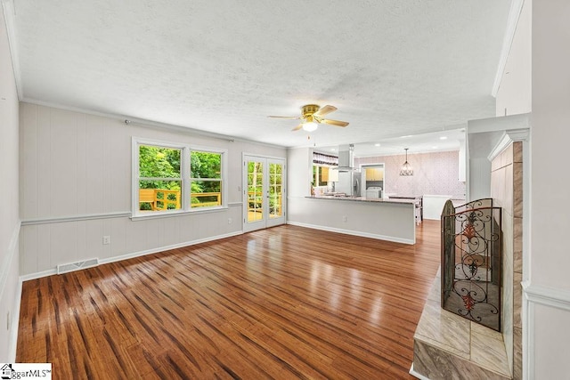 111 Bonwood Ave, Simpsonville, SC 29681 - unfurnished living room featuring wood finished floors, a ceiling fan, and a textured ceiling