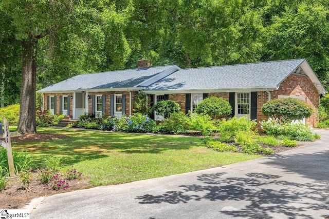 111 Bonwood Ave, Simpsonville, SC 29681 - ranch-style home featuring brick siding, a chimney, a front yard, and roof with shingles