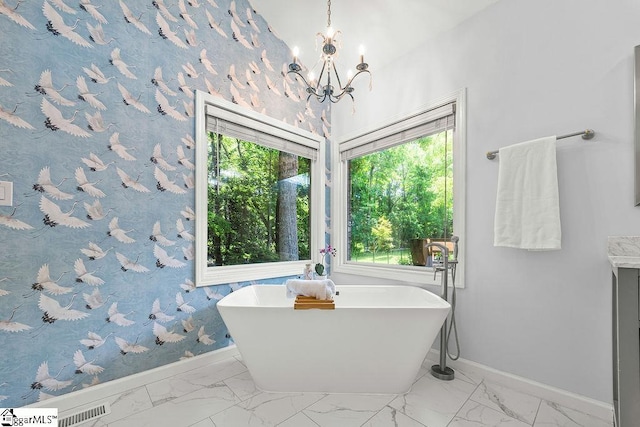 111 Bonwood Ave, Simpsonville, SC 29681 - full bathroom featuring marble finish floors, a freestanding tub, and a chandelier