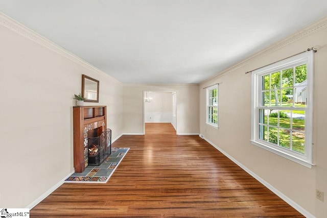 111 Bonwood Ave, Simpsonville, SC 29681 - unfurnished living room featuring wood finished floors, a tiled fireplace, and ornamental molding