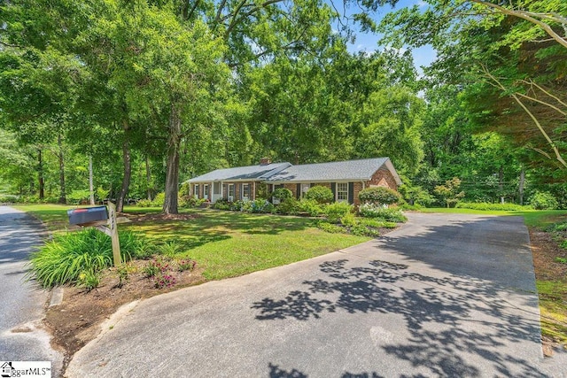 111 Bonwood Ave, Simpsonville, SC 29681 - view of front of home with a front yard, a chimney, asphalt driveway, and brick siding