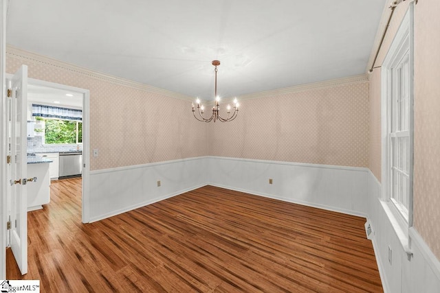 111 Bonwood Ave, Simpsonville, SC 29681 - spare room with wallpapered walls, wood finished floors, a chandelier, and ornamental molding