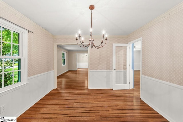111 Bonwood Ave, Simpsonville, SC 29681 - unfurnished dining area with plenty of natural light, a wainscoted wall, a chandelier, wood finished floors, and crown molding