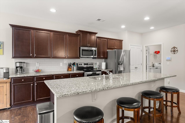 710 Westwood Rd, Lyman, SC 29365 - kitchen with appliances with stainless steel finishes, dark wood-type flooring, washer / dryer, decorative backsplash, and recessed lighting