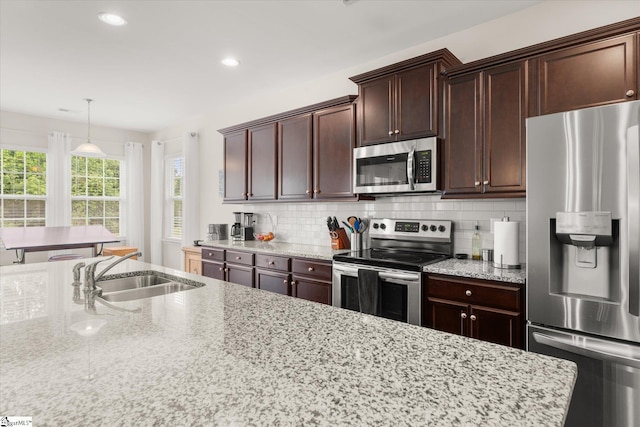 710 Westwood Rd, Lyman, SC 29365 - kitchen with appliances with stainless steel finishes, recessed lighting, decorative backsplash, light stone countertops, and pendant lighting