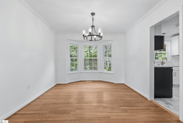 612 Walnut Way, Anderson, SC 29626 - unfurnished dining area featuring a chandelier, light wood-style flooring, crown molding, and a textured ceiling