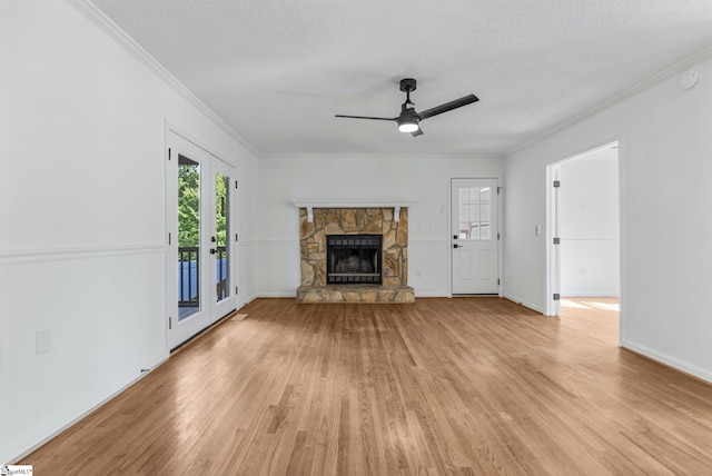 612 Walnut Way, Anderson, SC 29626 - unfurnished living room featuring light wood finished floors, ornamental molding, a stone fireplace, a ceiling fan, and a textured ceiling