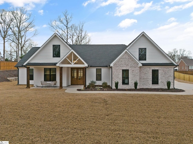 12 Beech Creek Ct, Greer, SC 29651 - modern farmhouse featuring french doors, roof with shingles, and covered porch