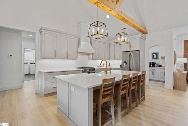 12 Beech Creek Ct, Greer, SC 29651 - kitchen with stainless steel appliances, high vaulted ceiling, a chandelier, light countertops, and an island with sink