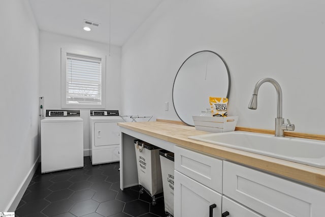 12 Beech Creek Ct, Greer, SC 29651 - laundry area with washer and clothes dryer, dark tile patterned floors, cabinet space, and recessed lighting