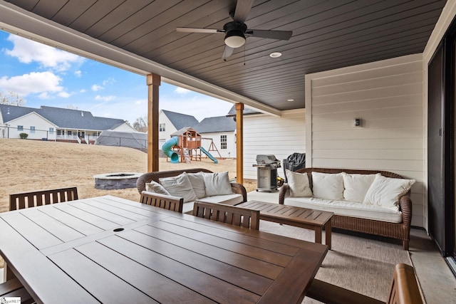12 Beech Creek Ct, Greer, SC 29651 - wooden deck with an outdoor living space with a fire pit, a playground, outdoor dining area, and ceiling fan