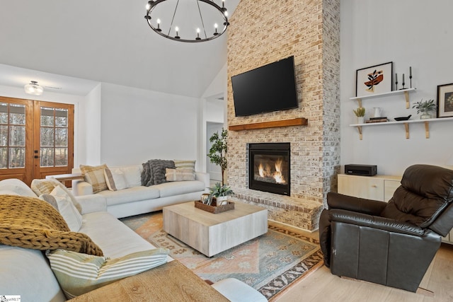 12 Beech Creek Ct, Greer, SC 29651 - living area with wood finished floors, french doors, high vaulted ceiling, a chandelier, and a fireplace
