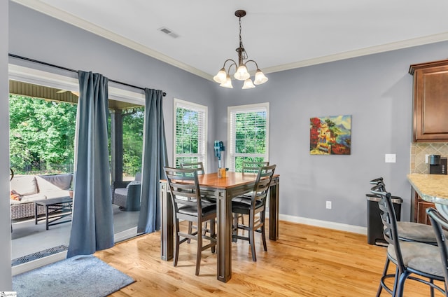 911 Devenger Rd, Greer, SC 29650 - dining area featuring ornamental molding, light wood-type flooring, and a chandelier