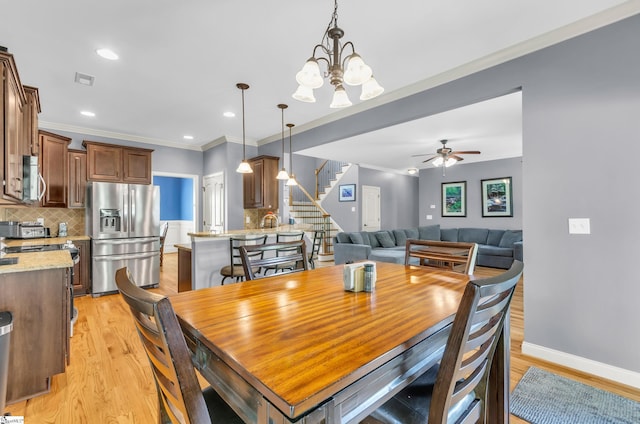 911 Devenger Rd, Greer, SC 29650 - dining space with stairway, light wood-style flooring, crown molding, a chandelier, and a ceiling fan