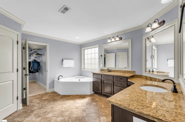 911 Devenger Rd, Greer, SC 29650 - bathroom with crown molding, two vanities, a bath, and a walk in closet