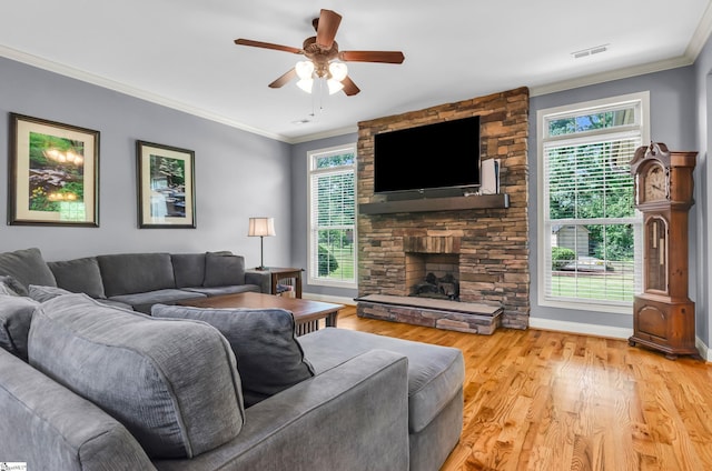 911 Devenger Rd, Greer, SC 29650 - living area featuring light wood-style floors, ceiling fan, a stone fireplace, and ornamental molding
