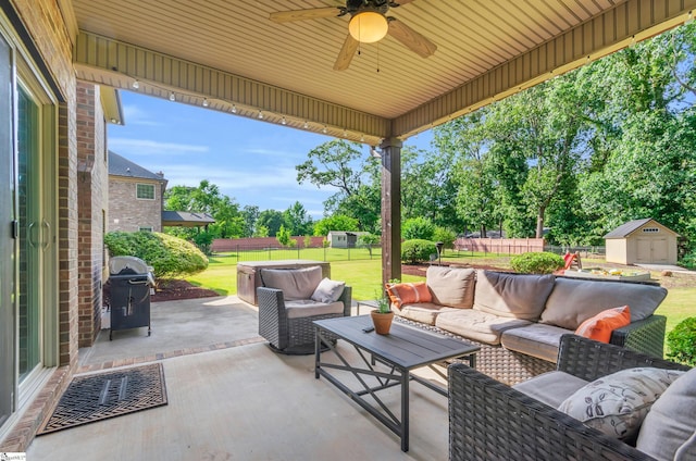 911 Devenger Rd, Greer, SC 29650 - fenced backyard featuring a patio, an outdoor hangout area, a storage unit, and a ceiling fan