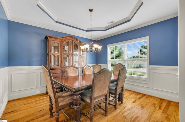 911 Devenger Rd, Greer, SC 29650 - dining area featuring wainscoting, a chandelier, light wood-style flooring, a raised ceiling, and ornamental molding