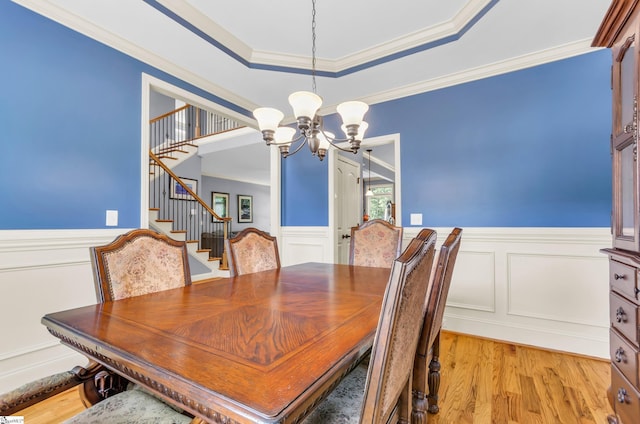 911 Devenger Rd, Greer, SC 29650 - dining space featuring a chandelier, wainscoting, stairway, ornamental molding, and light wood-style floors