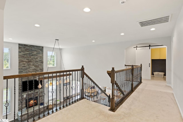 430 Cloverland Ln, Duncan, SC 29334 - hall featuring light colored carpet, a barn door, an upstairs landing, recessed lighting, and arched walkways