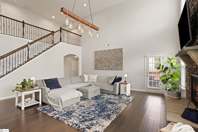 430 Cloverland Ln, Duncan, SC 29334 - living room with a stone fireplace, arched walkways, a high ceiling, hardwood / wood-style floors, and stairway