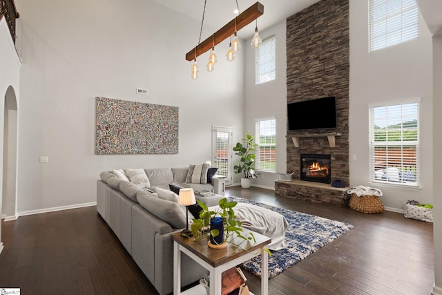 430 Cloverland Ln, Duncan, SC 29334 - living room with a high ceiling, arched walkways, dark wood-style flooring, and a stone fireplace