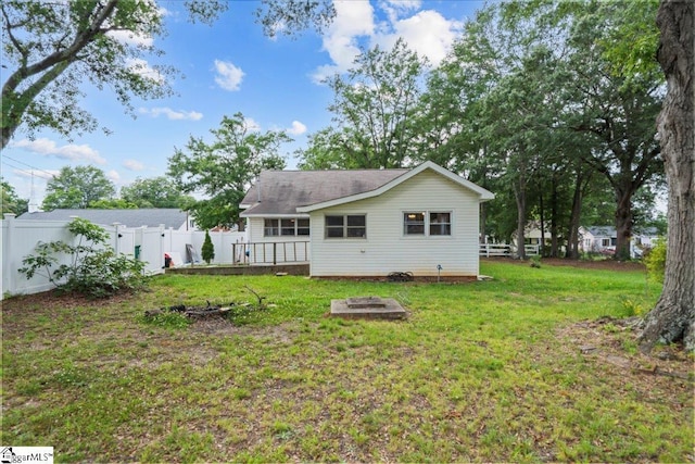 313 S Georgia Ave, Chesnee, SC 29323 - rear view of property with an outdoor fire pit, a fenced backyard, and a wooden deck
