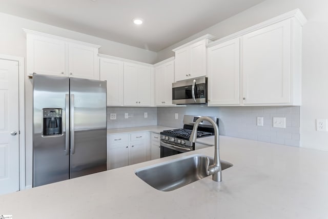 125 Magnolia St, Reidville, SC 29388 - kitchen with appliances with stainless steel finishes, tasteful backsplash, white cabinetry, and recessed lighting