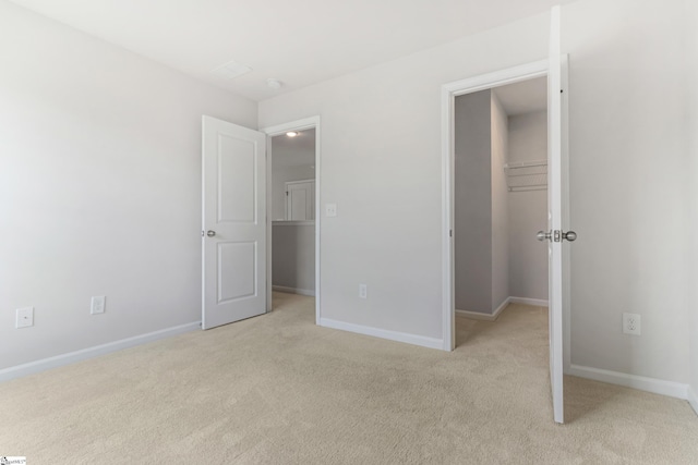 125 Magnolia St, Reidville, SC 29388 - unfurnished bedroom with a walk in closet, light carpet, and a closet