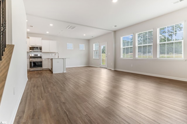 125 Magnolia St, Reidville, SC 29388 - unfurnished living room featuring wood finished floors and recessed lighting