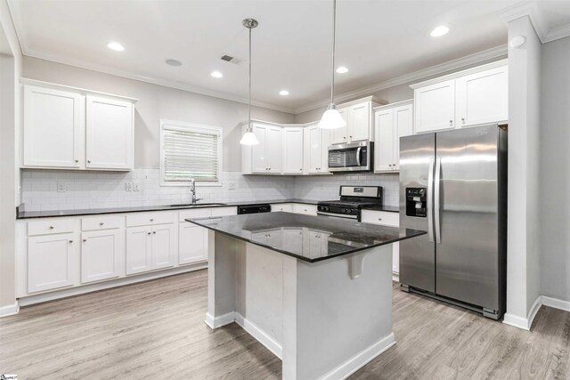 177 Viewmont Dr, Duncan, SC 29334 - kitchen with appliances with stainless steel finishes, white cabinetry, light wood-style flooring, crown molding, and backsplash