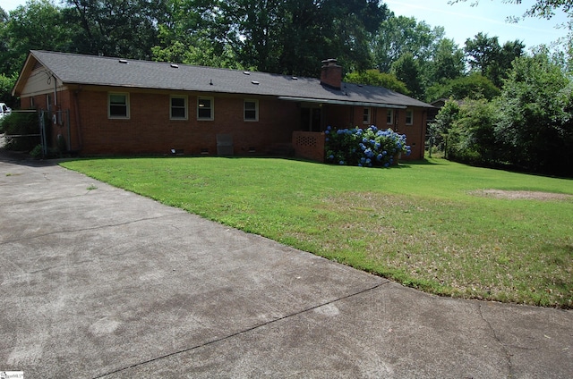 16 Heathwood Cir, Taylors, SC 29687 - back of property featuring a yard, brick siding, a chimney, crawl space, and concrete driveway