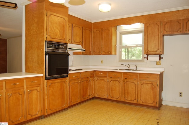 16 Heathwood Cir, Taylors, SC 29687 - kitchen with black oven, under cabinet range hood, light countertops, brown cabinetry, and ornamental molding