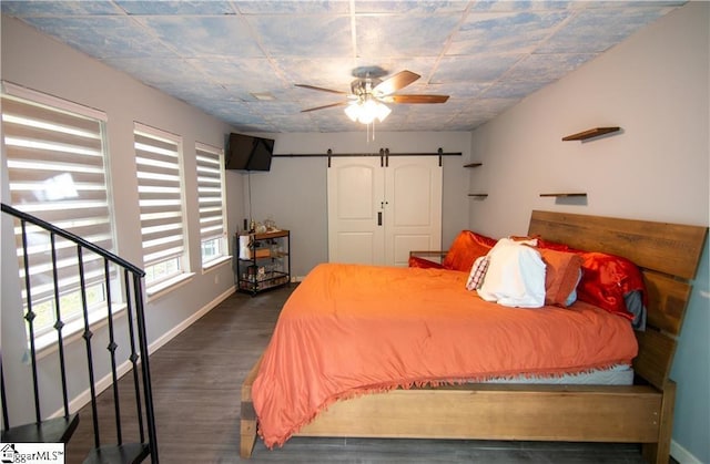 124 Grand Oak Dr, Pendleton, SC 29670 - bedroom with a barn door, dark wood-style floors, and ceiling fan