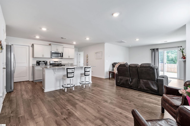 1808 Bridle Ln, Roebuck, SC 29376 - living room featuring dark wood-style floors and recessed lighting