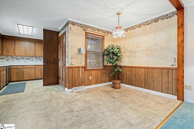 200 Camille St, Easley, SC 29642 - unfurnished dining area featuring a chandelier, wainscoting, wooden walls, light floors, and ornamental molding