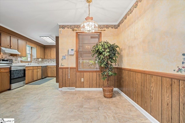 200 Camille St, Easley, SC 29642 - kitchen with appliances with stainless steel finishes, under cabinet range hood, a chandelier, a wainscoted wall, and light countertops