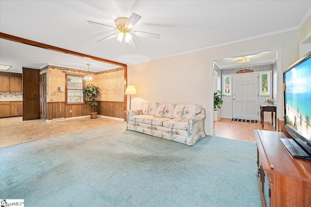 200 Camille St, Easley, SC 29642 - carpeted living room featuring ornamental molding, a chandelier, wood walls, ceiling fan, and wainscoting