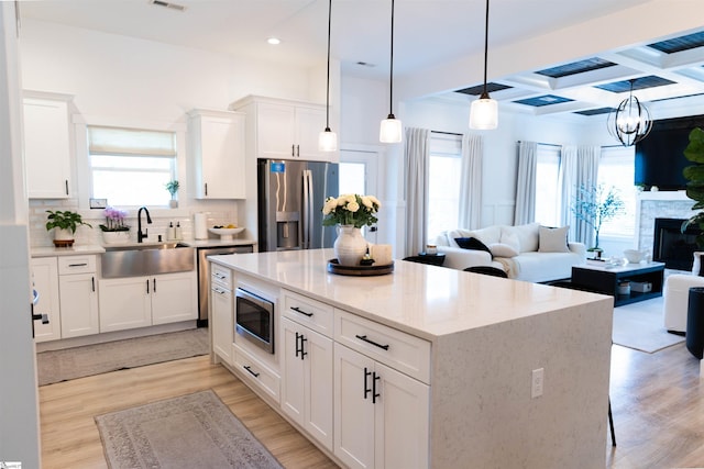 140 Holmes Dr, Spartanburg, SC 29303 - kitchen featuring stainless steel appliances, plenty of natural light, a kitchen island, light wood-type flooring, and beam ceiling