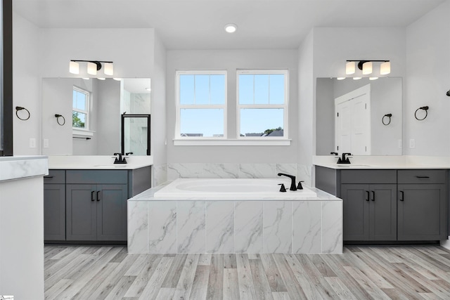 913 Wild Pine Ct, Duncan, SC 29334 - full bathroom with wood finished floors, a bath, and two vanities