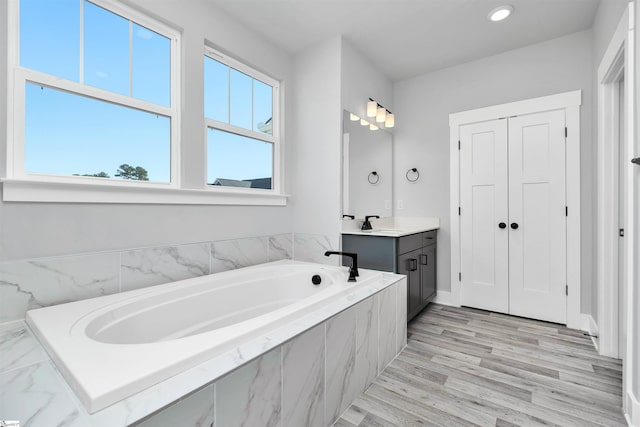 913 Wild Pine Ct, Duncan, SC 29334 - bathroom with vanity, a bath, wood finished floors, and recessed lighting