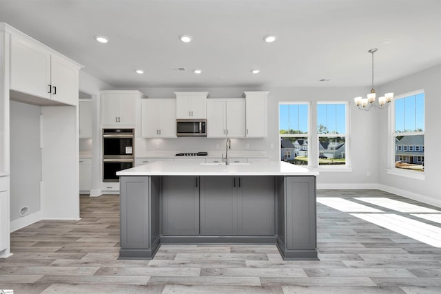 913 Wild Pine Ct, Duncan, SC 29334 - kitchen featuring appliances with stainless steel finishes, a chandelier, a center island with sink, recessed lighting, and white cabinets