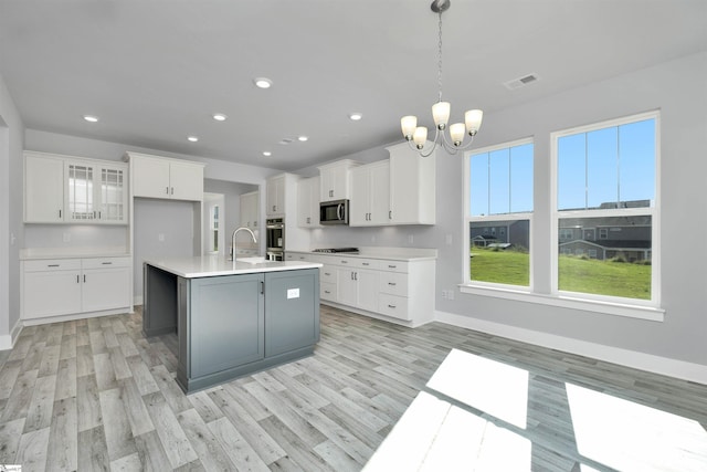 913 Wild Pine Ct, Duncan, SC 29334 - kitchen with a chandelier, light wood-type flooring, white cabinets, appliances with stainless steel finishes, and recessed lighting