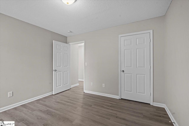 263 Cornelson Dr, Greer, SC 29651 - unfurnished bedroom featuring wood finished floors and a textured ceiling