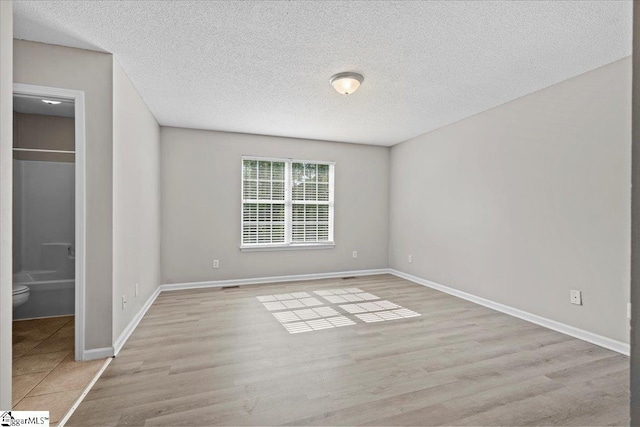 263 Cornelson Dr, Greer, SC 29651 - unfurnished bedroom featuring wood finished floors and a textured ceiling
