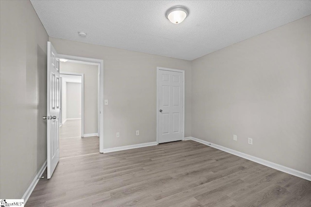 263 Cornelson Dr, Greer, SC 29651 - unfurnished bedroom featuring wood finished floors and a textured ceiling