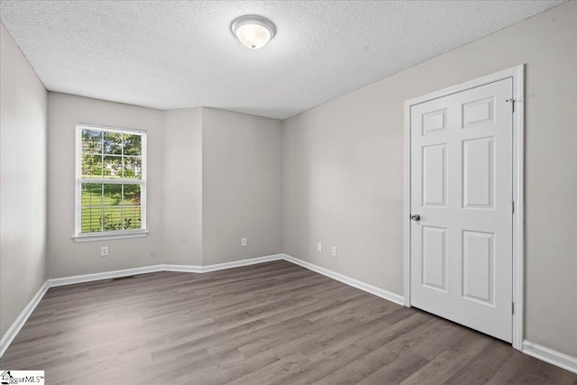 263 Cornelson Dr, Greer, SC 29651 - empty room with wood finished floors and a textured ceiling