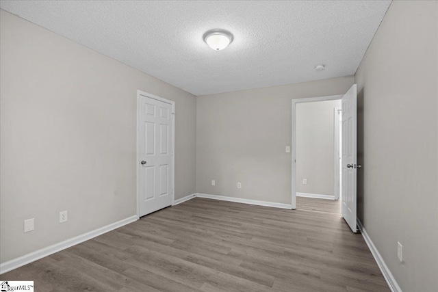 263 Cornelson Dr, Greer, SC 29651 - unfurnished bedroom featuring a textured ceiling and wood finished floors